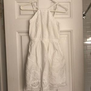White high neck mini dress with eyelet details.